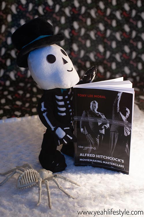 Skeleton holding The Young Alfred Hitchcock's Moviemaking Master Class Book